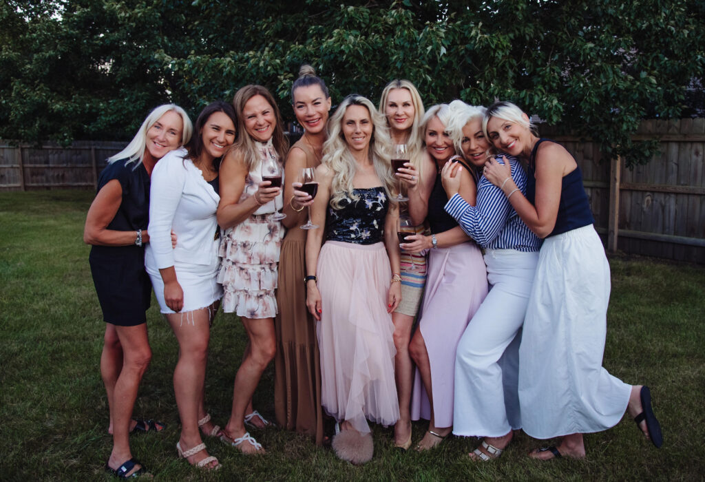 A group of friends holding wine glasses outdoors at Solasta